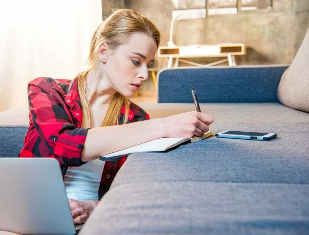 Woman taking notes at home