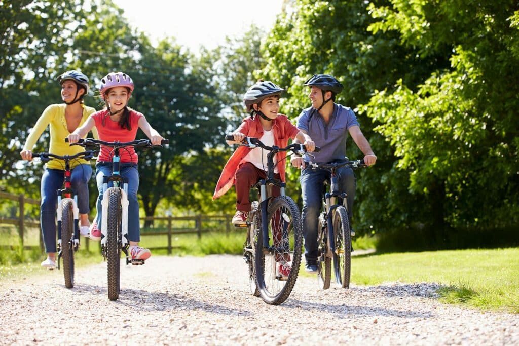 family with two children riding a bicycle